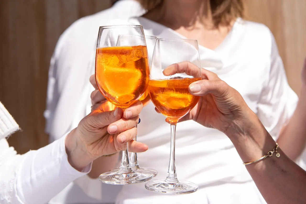 glasses, drink, alcohol, cocktail, party, beverage, liquor, refreshment, alcoholic, celebration, orange, aperol, aperol spritz, toast, cheers, celebrate, hands, friendship, alcohol