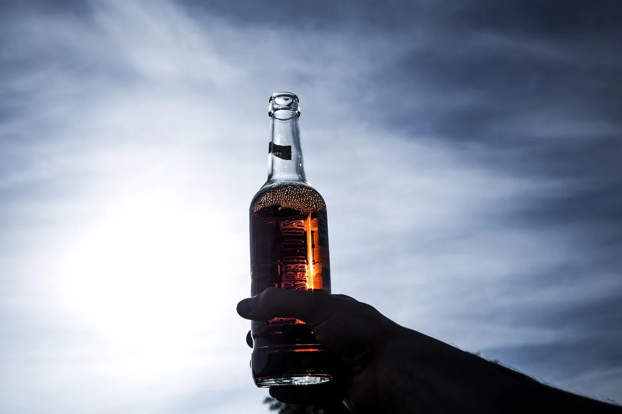 alcoholic, drinks, beer, beverage, bottle, clouds, dark, daylight, hand, light, nature, liquor, blue bottle. Buying zero proof beverages by the finished serve: five checks